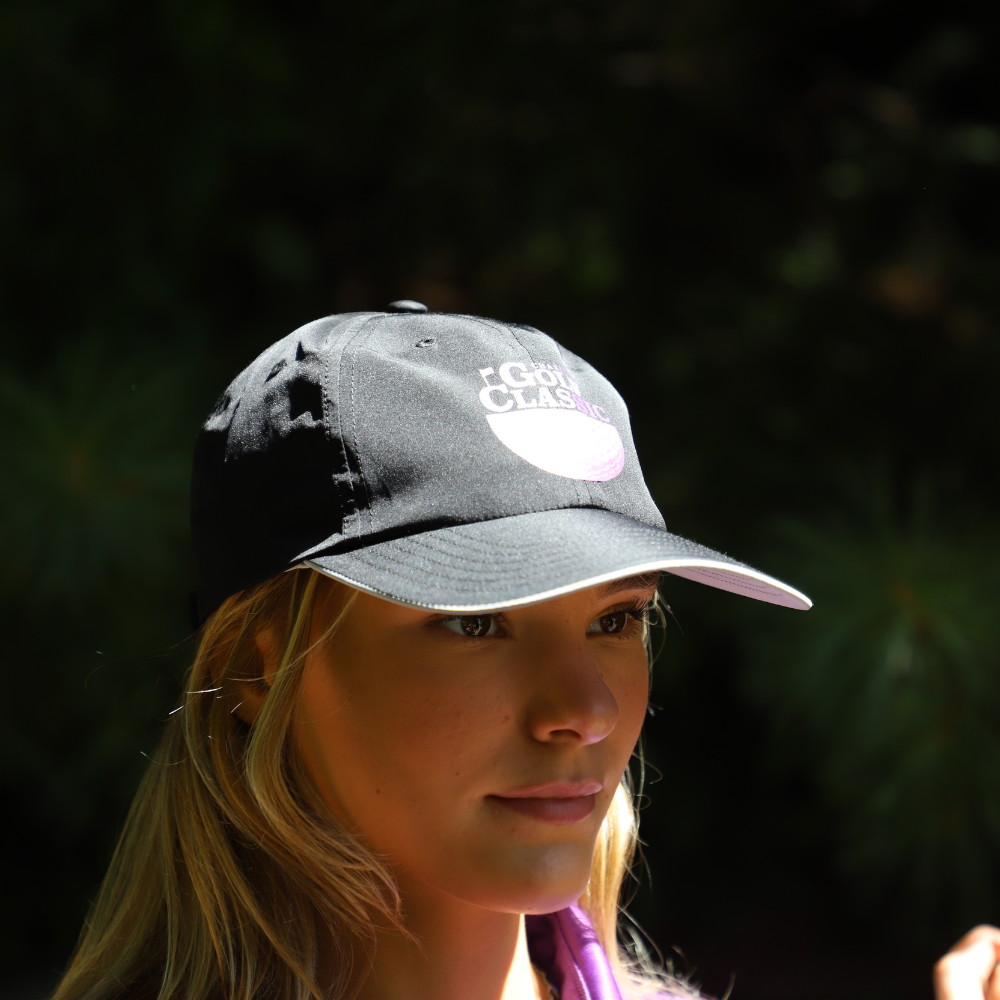 side view of girl with black golf hat