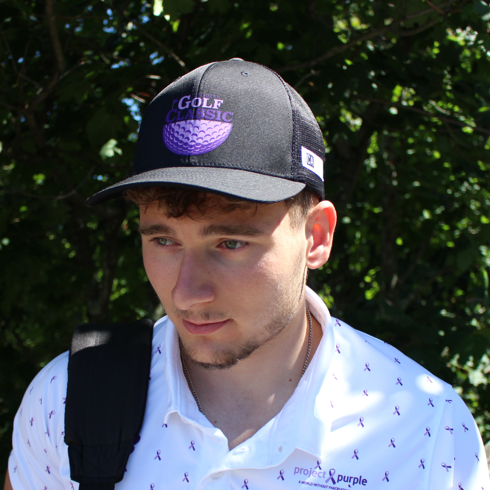 front view of boy with black golf hat