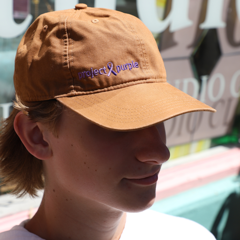 side view of boy with brown hat