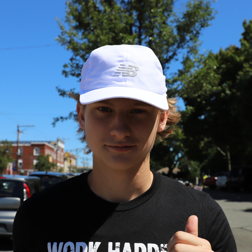 boy with white new balance hat