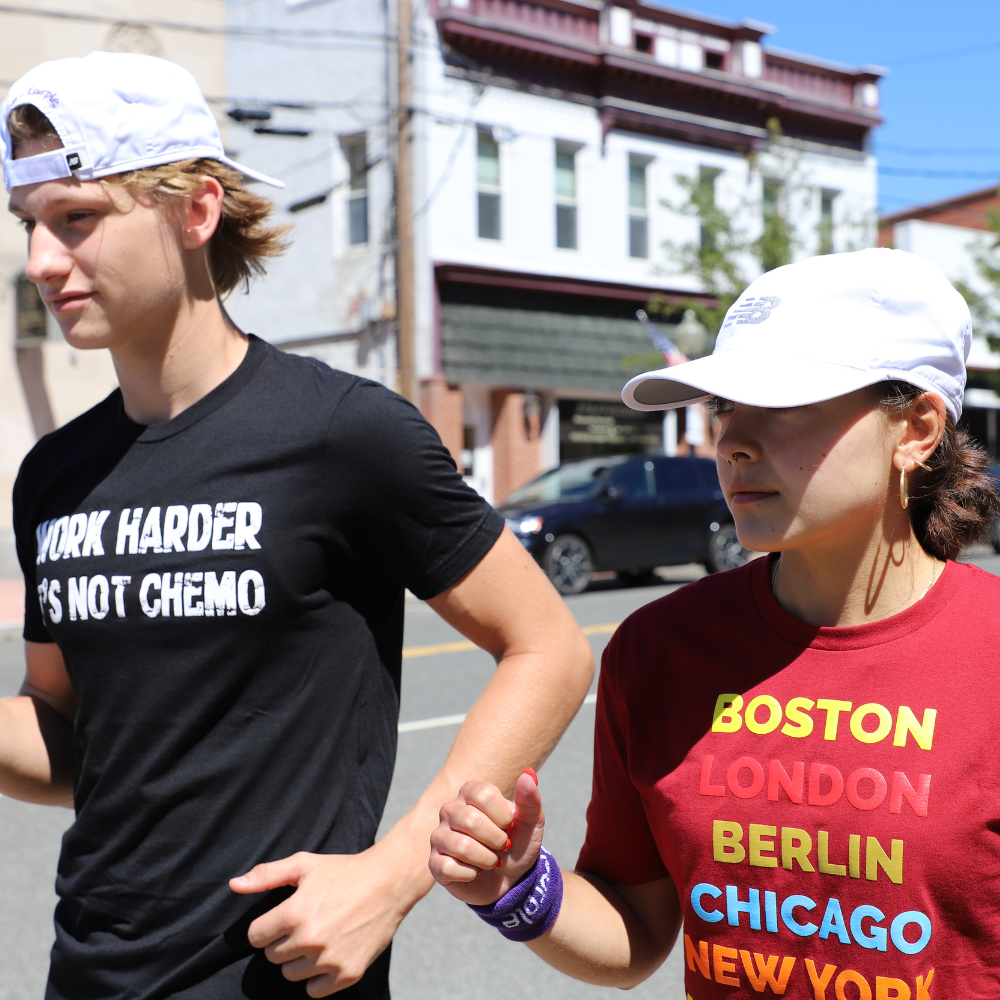 boy and girl running with white hats