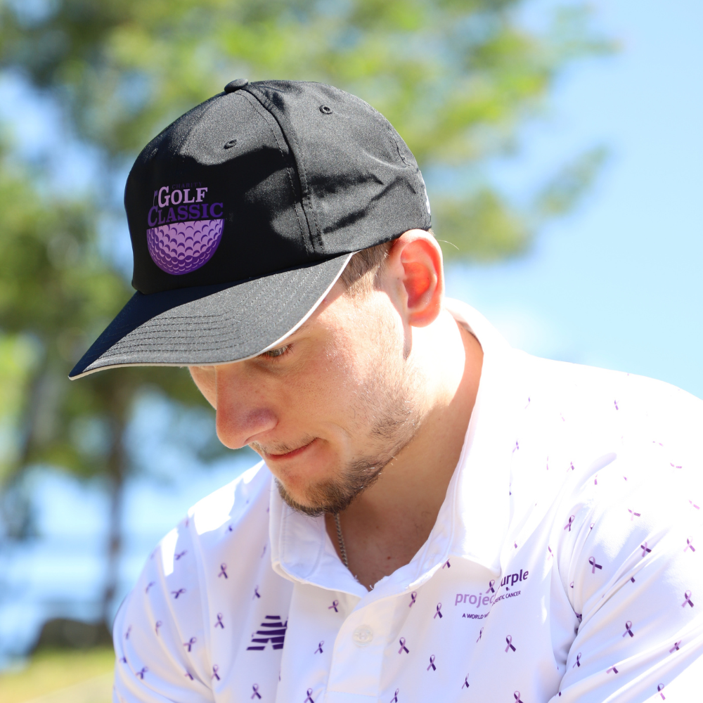 side view of boy with black golf hat