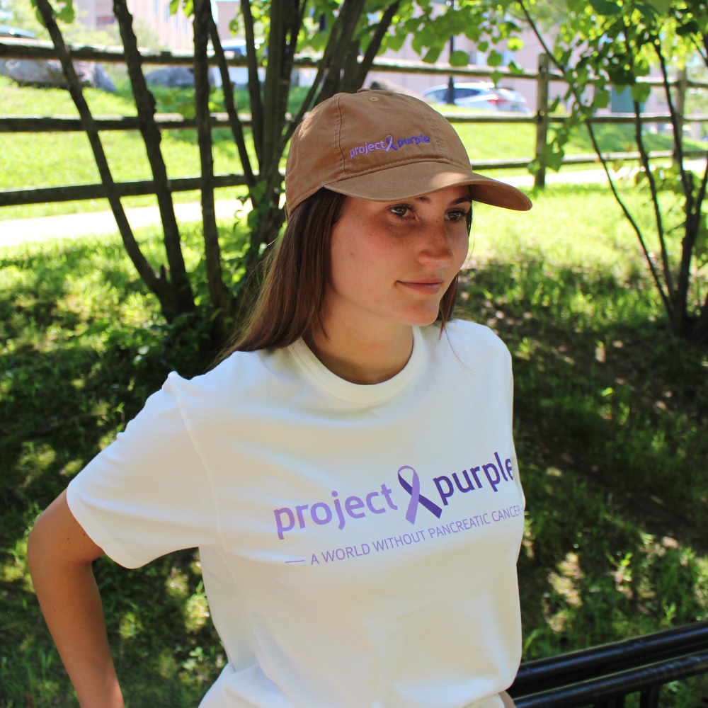 smiling girl with white project purple tee