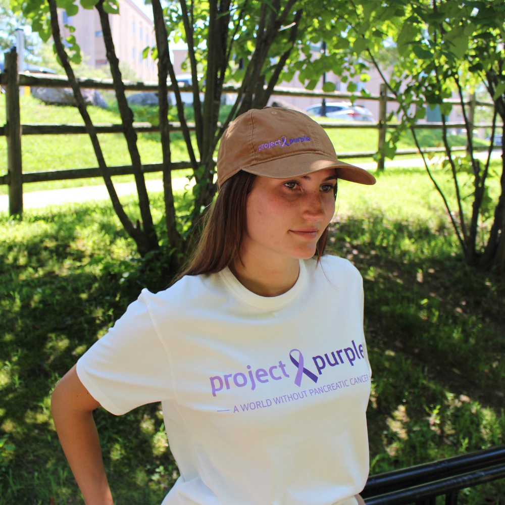 girl with white shirt and brown  hat