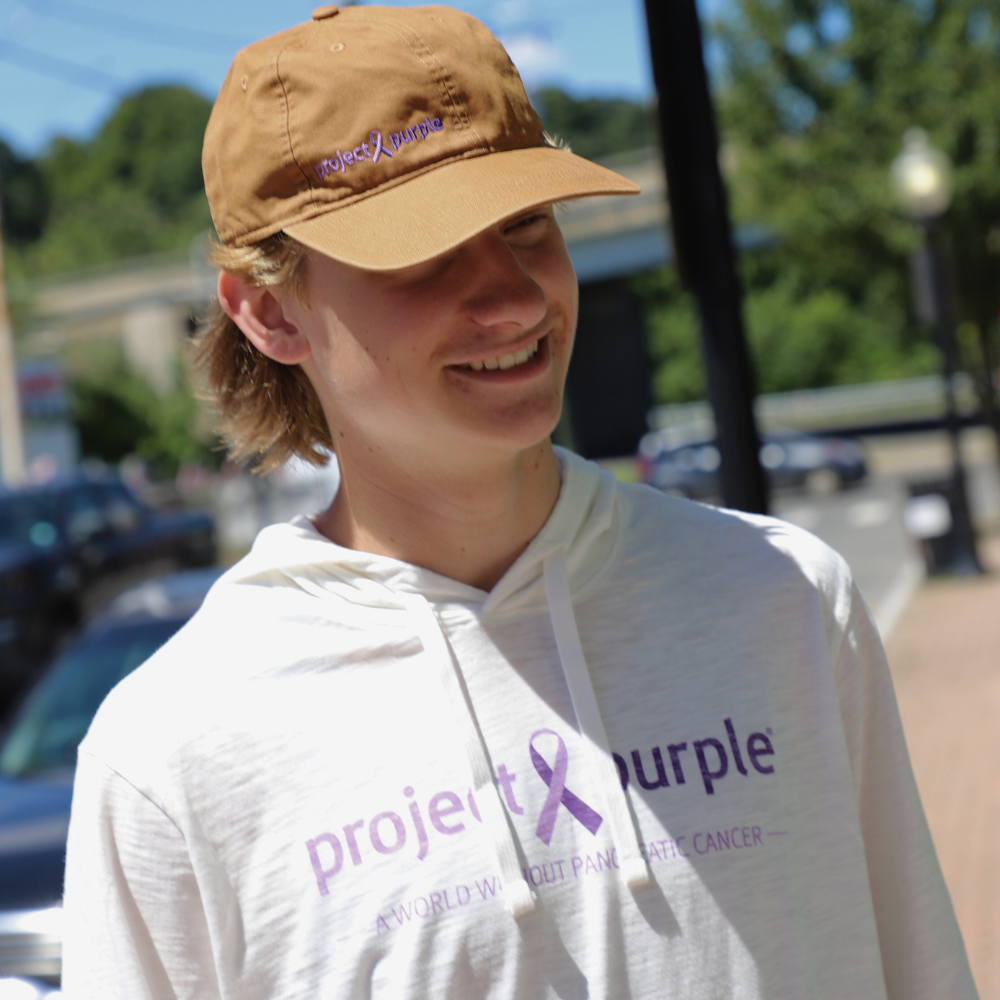 smiling boy with project purple long sleeve