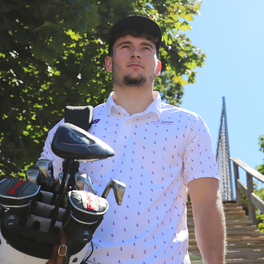 boy with white golf polo and clubs