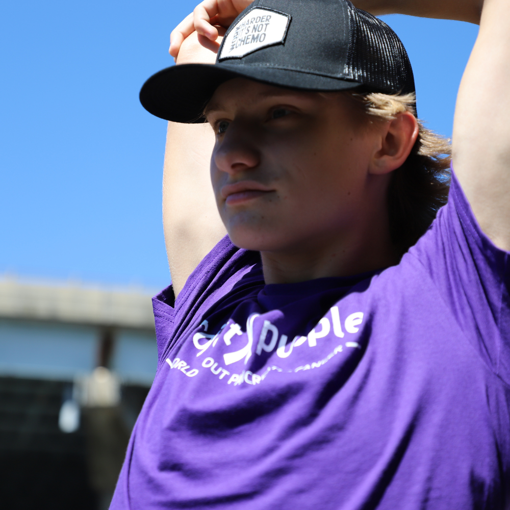 close up of boy with purple shirt