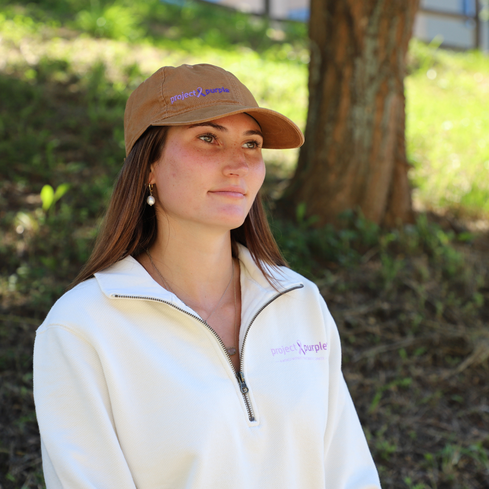 girl with brown hat and white sweater