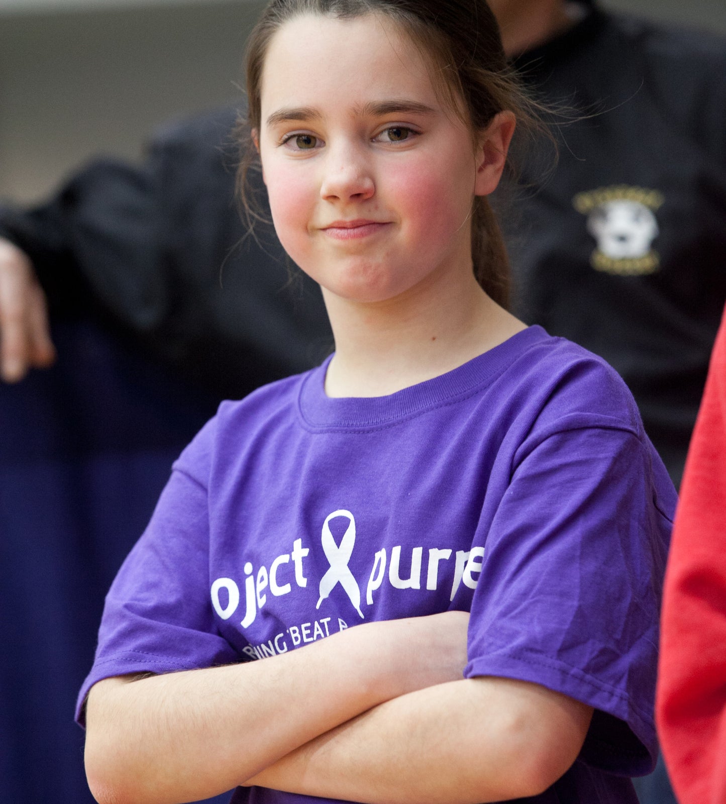 child wearing Purple shirt with white project purple logo