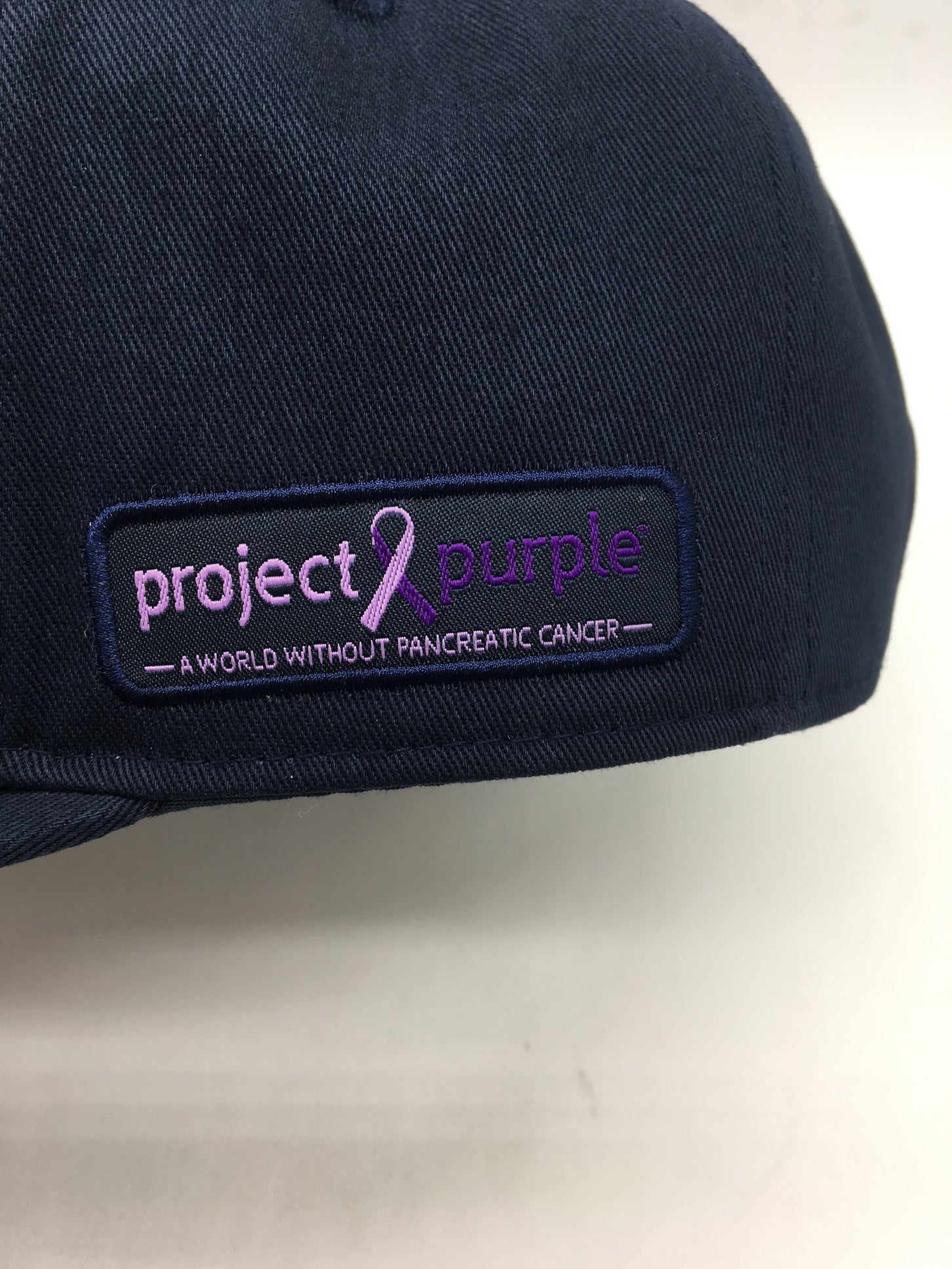 Close up view of Project Purple Logo on Yankee hat